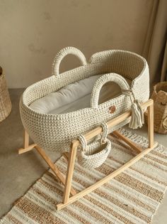 a wicker baby crib on a rug with a teddy bear in the background