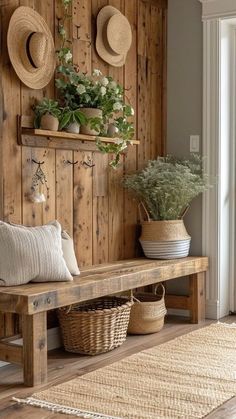 a wooden bench sitting next to a wall with hats on it