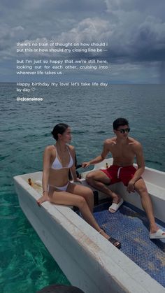 two people sitting on the back of a boat in the ocean with a poem written below