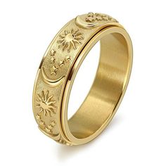 a gold wedding ring with flowers and stars on the side, in front of a white background