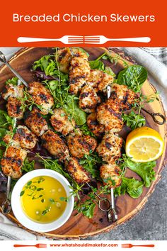 chicken skewers on a wooden platter with lemons