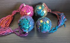 crocheted balls with tassels are on the table