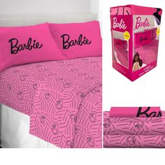 pink bedding with barbie dolls on it and the box next to it that says barbie