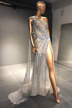 a mannequin dressed in an evening gown with one leg slited and the other side open