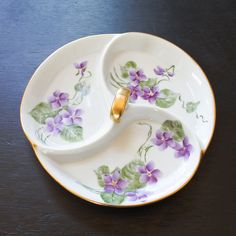 two white dishes with purple flowers on them