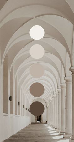 an empty hallway with columns and round lights on the ceiling in sepia toned photograph