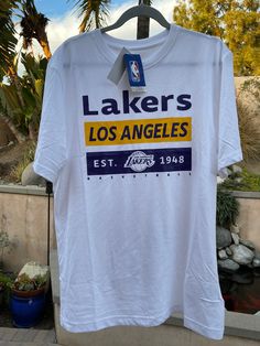 a los angeles lakers t - shirt hanging on a rack