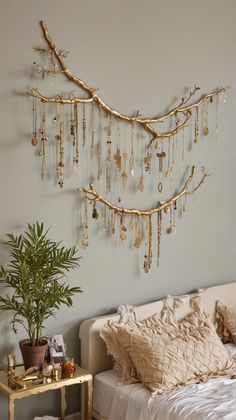 a bedroom with a bed, plant and jewelry hanging on the wall