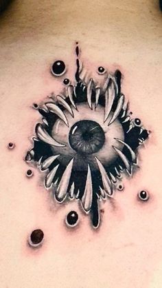 a black and white tattoo design on the back of a woman's upper body