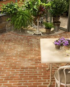 a table and chairs sitting on a brick patio