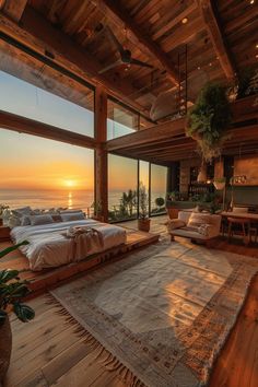 a bedroom with a large rug on the floor next to a window overlooking the ocean