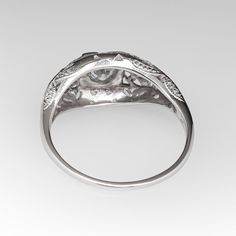 This beautiful circa 1940s ring features a pierced design and is bordered with milgrain edging. The ring is centered with one (1), bead set, round transitional brilliant cut diamonds. The center stone is flanked to each side by one (1), bead set, round transitional brilliant cut diamond. The ring measures 8.3mm at the top, rises 4.2mm above the finger, tapering to 0.9mm wide and 0.8mm thick at the base of the shank. The ring is currently a size 5.5 and we offer complimentary resizing to fit. 1940s Ring, Filigree Engagement Ring Vintage, Filigree Engagement Ring, Garnet Jewelry, Bead Set, One 1, Vintage Diamond, High Quality Jewelry, Brilliant Cut Diamond