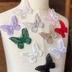 the back of a mannequin with many different colored butterflies on it