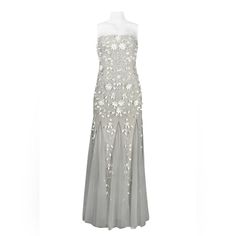 a dress with white flowers on it and silver mesh overlaying the top,