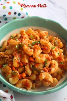 a bowl filled with pasta and vegetables on top of a table