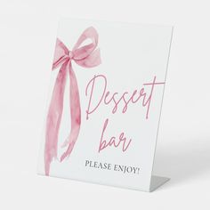 a sign that says dessert bar please enjoy with a pink bow on it's front