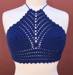 a mannequin wearing a blue crochet halter top