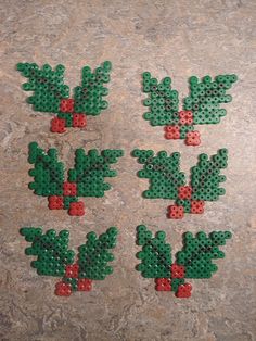 four green and red christmas decorations made out of perler beads