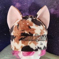 a brown and white cat ears hat on top of a mannequin head