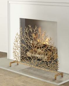 a white fireplace with a gold fire place