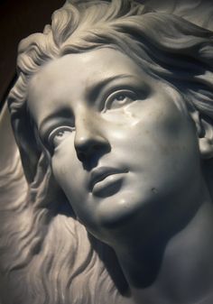 a statue of a woman's head is shown in black and white