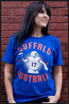 Buffalo Football Shirt. A homage shirt to our new franchise QB. A great shirt for some one who is Buffalo Football fan too! All of our shirts are printed on high quality, ultra soft, 100% cotton preshrunk American Apparel t-shirts. All printing is done in-house and is American made. Main design is on front. for more shirts visit our site: www.mybuffaloshirt.com Tri-blend T-shirt With Graphic Print For Fans, Sports Fan T-shirt With Short Sleeves, Crew Neck T-shirt With Screen Print For Fan Events, Team Spirit T-shirt With Screen Print For Fan Gear, Pre-shrunk Band Merch T-shirt For Fan Conventions, Graphic Tee With Screen Print For Fan Events, Tri-blend Graphic Tee For Fan Merchandise, Graphic Tee For Fan Events With Screen Print, Fan Merchandise Logo Print T-shirt