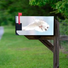 a mailbox with a white bird on it