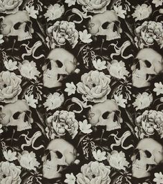 a black and white photo of a skull with roses on it