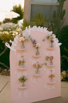 a pink sign with flowers on it