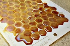 a close up of a honeycomb with syrup on it