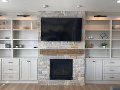 a living room filled with furniture and a flat screen tv mounted on the wall above a fireplace