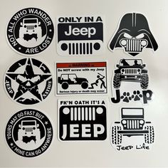 various stickers are displayed on a white surface, including jeeps and star wars logos