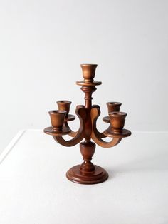 "This is a mid 20th century wooden candelabra.  The turned wood candlestick holder holds five tapers.  CONDITION In good condition with wear consistent with age and use.  MEASUREMENTS Height: 12.75\"  ..  32.4 cm Width:  9\"  ..  22.9 cm Depth: 9\"  ..  22.9 cm 92355" Wooden Candlestick Holders, Wooden Candlestick, Pvc Pipe Crafts, Antique Candle Sticks, Lathe Projects, Wooden Candle Sticks, Wood Candle, Wood Candle Sticks, Woven Baskets Storage