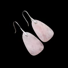 Introducing our exquisite Rose Quartz Drop Earrings in Sterling Silver – a harmonious blend of timeless elegance and natural beauty. These enchanting earrings are crafted with meticulous attention to detail, combining the lustrous allure of sterling silver with the gentle, rosy hues of genuine rose quartz. The focal point of each earring is a delicately faceted rose quartz gemstone, gracefully suspended from a polished sterling silver setting. The soothing pink tones of the rose quartz evoke a s Elegant Nickel-free Rose Quartz Earrings, Pink Rose Quartz Jewelry With Matching Earrings, Pink Rose Quartz Drop Earrings, Elegant Rose Quartz Gemstone Earrings, Pink Sterling Silver Earrings For Pierced Ears, Elegant Teardrop Rose Quartz Earrings, Feminine Sterling Silver Dangle Jewelry, Elegant Nickel-free Pink Jewelry, Classic Pink Sterling Silver Earrings