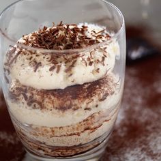 a dessert in a glass on top of a table