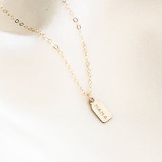 Customizable and endlessly cute, the Dainty Tag Necklace is perfect for you and your loved ones. Personalize it with your initials or the letters of your choice, then enjoy showing it off at work and with friends! You can also leave it blank for a chic, minimal look. Makes a great gift for family and friends...and yourself! DETAILS Necklace length: 16" with 2" extender 14k gold filled -or- sterling silver charm, chain, clasp, & findings Charm measurements: 9mm x 4.5mm, not including the bail Add Mama Necklace, Detailed Necklace, Necklace Extender, Hand Stamped Necklace, Charm Chain, Gold Filled Ring, Everyday Necklace, Cute Necklace, Birthstone Charms