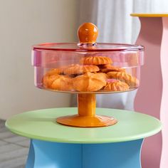 there is a cake stand that has cookies in it