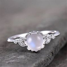 a white ring sitting on top of a rock