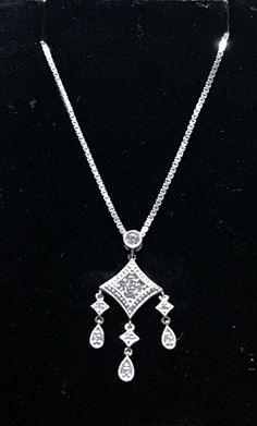 "Solid 14K White Gold Diamond Pendant Necklace 18\" My ex purchased this for me from a jeweler in NYC and it was EXPENSIVE!! STUNNING diamond pendant crafted beautifully in 14k White gold and genuine diamonds! The pendant measures approximately 1 1/4 long x 1/2\" wide. Chain is a nice weight box chain, 18\" long. 4.6 grams total weight. GREAT DEAL!! Please message me with any questions Shipped insured/delivery confirmation I guarantee item to be exactly as described and pictured." Fine Jewelry Necklaces With Diamond Cut Dangle, Fine Jewelry Dangle Necklaces With Diamond Cut, Dangle Necklaces With Diamond Accents, Classic Diamond Cut Drop Pendant Necklace, Classic Diamond Dangle Necklaces, Diamond Cut Pendant Necklace, Diamond White Dangle Necklace For Anniversary, Fine Jewelry Drop Necklace With Diamond Accents, Anniversary Dangle Diamond Necklace