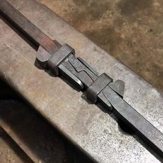 a close up of a piece of metal on a table with some tools in it