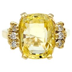 Ring Size: 5.25 Embrace the warmth and radiance of this cushion cut yellow sapphire ring, a true embodiment of elegance in polished yellow gold. The cushion-cut yellow sapphire, resplendent in its sunny hue, sits majestically as the centerpiece, radiating positivity and sophistication. Surrounding the vibrant sapphire are round white diamonds, delicately flanking the main stone on either side. Their brilliance adds a touch of timeless sparkle, creating a captivating contrast against the golden glow of the yellow sapphire. The polished yellow gold setting enhances the overall allure, providing a seamless backdrop that complements the rich tones of the gemstones. This ring is a celebration of both color and brilliance, a perfect harmony of the unique charm of the yellow sapphire and the clas Radiating Positivity, Yellow Sapphire Ring, Yellow Sapphire Rings, Smart Jewelry, Diamond Cocktail Ring, Gold For Sale, Diamond Cocktail Rings, Yellow Gold Setting, Flower Motif