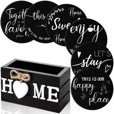 some black and white coasters with the words home written on them next to a box