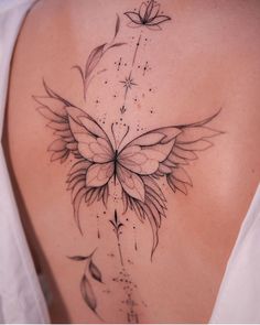 a woman's back with a butterfly tattoo on it