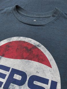 Vintage Never Looked So Good There's nothing like a classic Pepsi Cola! Inspired by the refreshing and absolutely timeless taste - our team created a retro 70s-inspired tee just for Pepsi fans. We selected the classic 70s Pepsi logo and gave it a fun, distressed and faded look. To complete the vintage feel on this Pepsi logo shirt - we've printed it on the highest quality, poly-cotton navy heather tee we could find. Poly/cotton blend Machine Wash Tumble Dry Regular Fit Printed in USA Retro Tri-blend Crew Neck T-shirt, Retro Crew Neck Top With Graphic Print, Retro Graphic Print Crew Neck Top, Retro Fan Merchandise T-shirt With Front Print, Retro Cotton Tops With Logo Print, Retro Tri-blend T-shirt With Front Print, Retro Crew Neck Tops With Screen Print, Retro Soft-washed T-shirt For Fan Merchandise, Retro Soft-washed Crew Neck T-shirt