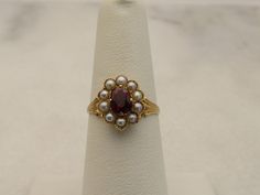 14k yellow gold estate wonderful almandine garnet ring with pearls. size 6 and in great shape. 2.2 grams. 12.4mm wide. center stone is 6.3mm by 4.5mm. beautiful. the almandine garnet is very red in color. mark is there but fadded acid tests for 14k. will come in nice ring box. Vintage Pearl Ring Antique, Antique Gold Pearl Ring With Gemstone, Heirloom Gold Garnet Rings, Garnet Pearl Ring, Antique Garnet Rings As Gift, Ring With Pearls, Garnet Ring Vintage, Italy Jewelry, Almandine Garnet