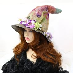 "Ready for the renfair, cosplay, a photo shoot, or your Spring table centerpiece - this frog fairy princess witch hat is hand felted and rich in color! Flowers surround the hat, and a removable crowned frog pin peeks out from the flowers - perhaps a kiss? The backdrop is filled with color with surrealistic flowers felted in, giving a dimensional painted picture backdrop. I graduated the color to give the feel of a perfect fairy-tale day, and bamboo with silk provides the depth and painted effect Whimsical Purple Costume Hats For Halloween, Whimsical Purple Halloween Costume Hats And Headpieces, Whimsical Purple Halloween Costume Hat, Whimsical Top Hat For Halloween Themed Events, Whimsical Mini Hats For Halloween Costume, Whimsical Costume Hat With Curved Brim For Costume Party, Whimsical Curved Brim Hat For Costume Party, Whimsical Halloween Cosplay Costume Hats, Whimsical Handmade Halloween Costume Hats And Headpieces