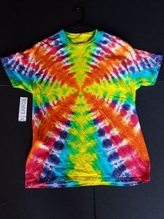 Tie dye shirt rainbow radio wave. Started life as a size Adult XLarge and now has been washed and shrunk. 100% cotton using procion dyes. If you have sizing concerns please message me before ordering. Shipping is included in the price. Prop clothes hanger is not included. Expect shipping in 1 to 3 business days. Cotton Tie Dye T-shirt With Rainbow Print, Colorful Hippie Cotton Tops, Rainbow Cotton Shirt For Summer, Cotton Tie Dye Top With Rainbow Print, Rainbow Hand Dyed Short Sleeve Tops, Rainbow Colored Hand Dyed Short Sleeve Tops, Radio Wave, Tie Dye Shirt, Dye Shirt