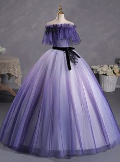 Knit from the fabric of dreams, this Quinceanera gown embodies the enchanting transition from daylight to dusk. The delicate purple hues of the tulle skirt are kissed with sparkles, evoking the first twinkling lights of the evening sky. The ruffled off-the-shoulder neckline, trimmed with dark lace, adds a touch of whimsical charm, while the black velvet belt provides an element of sophistication. This dress captures the essence of a magical evening, perfect for a young woman's significant rite of passage. Purple Ombre Wedding Dress, Fairy Gown, डिजाइनर कपड़े, Dress Quinceanera, Velvet Belt, Short Sleeve Wedding Dress, Pretty Quinceanera Dresses, Purple Dresses, Fantasy Dresses