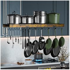 pots and pans hanging from a rack in a kitchen