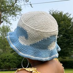 a woman wearing a crocheted hat with blue and white stars on it